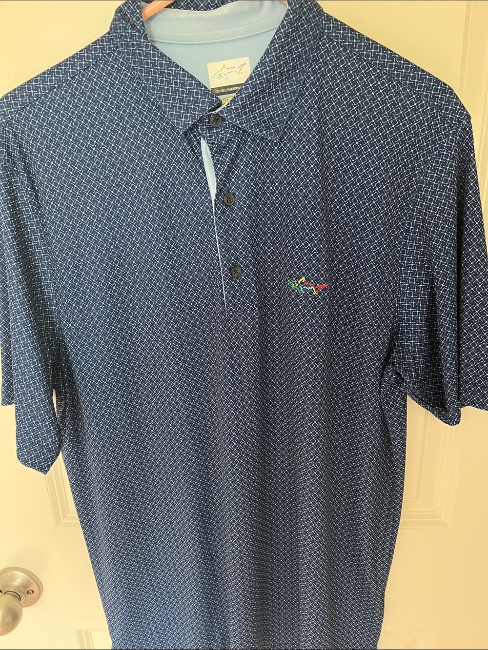 Greg Norman Collection Navy Geometric Polo with Multicolor Shark Logo